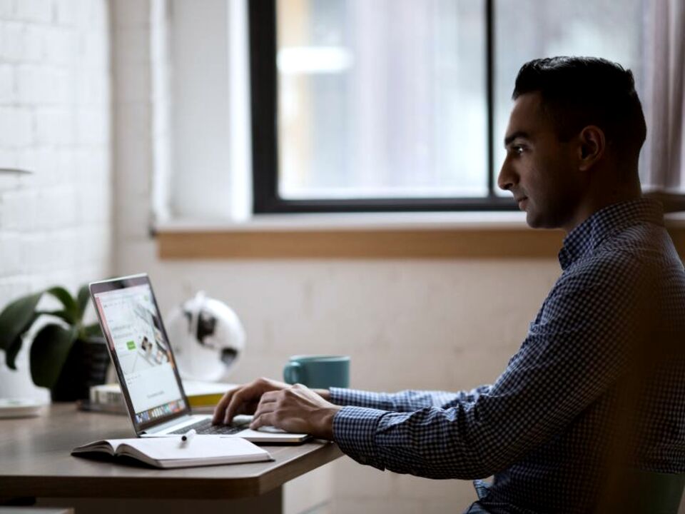 A person working at a desk by a window