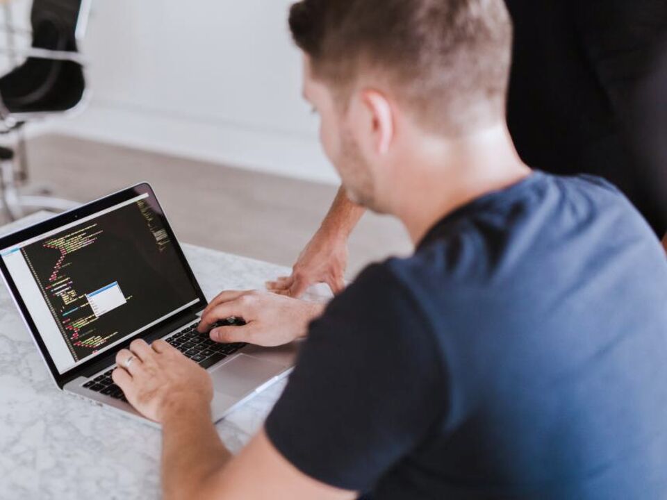 Someone learning to code on a laptop